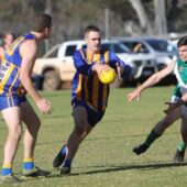 Bridgetown’s Nathan Introvigne hurries a kick out of defence.
